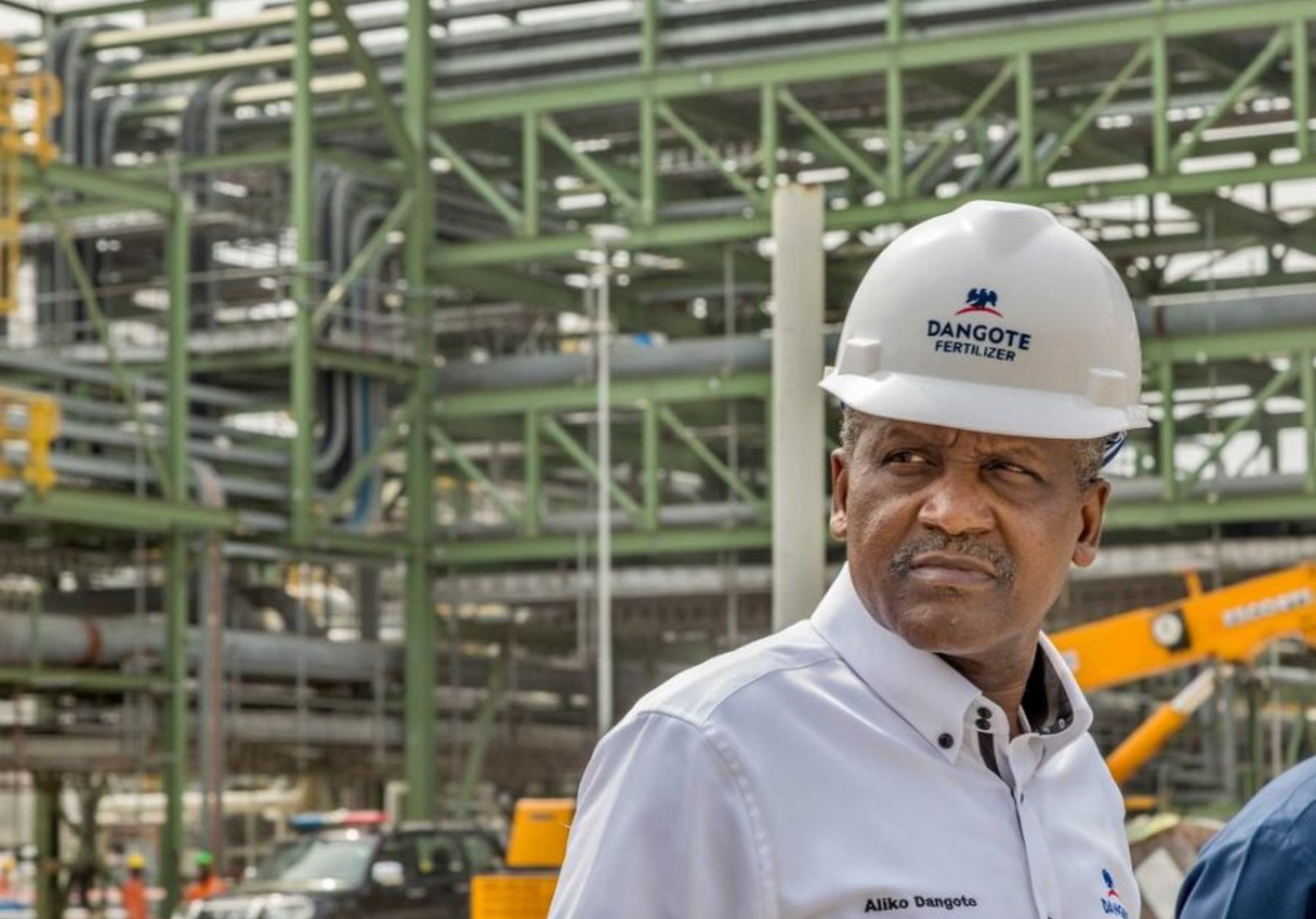 Aliko Dangote standing at the Dangote Fertiliser plant in Lagos, a landmark project driving Africa’s food security