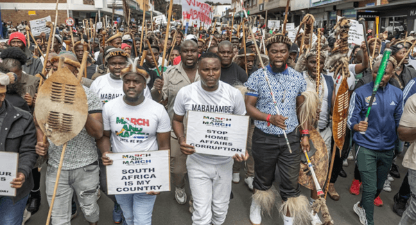 March and March demonstrators protest against foreigners on the streets of South Africa, holding placards and traditional shields.
