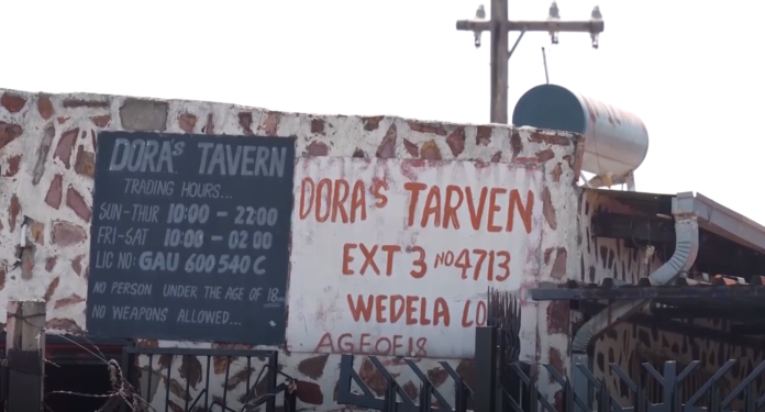 South African police at the scene of the Wedela tavern shooting in Gauteng, where 17 people were killed and 15 wounded.